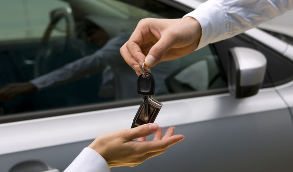 woman receiving car key from man